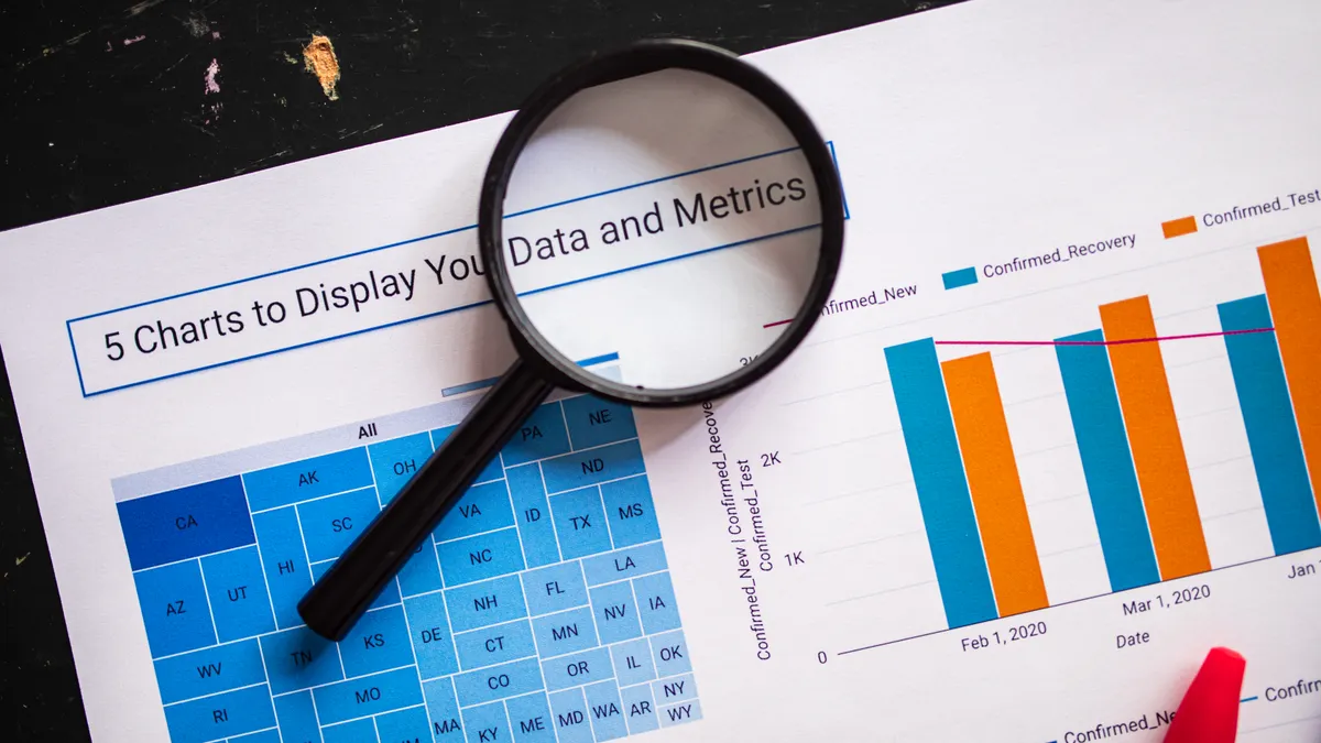 Magnifying glass over charts and data metrics
