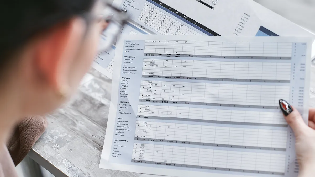 What file formats and inputs work best for bulk AI content generation Person reviewing a printed spreadsheet table